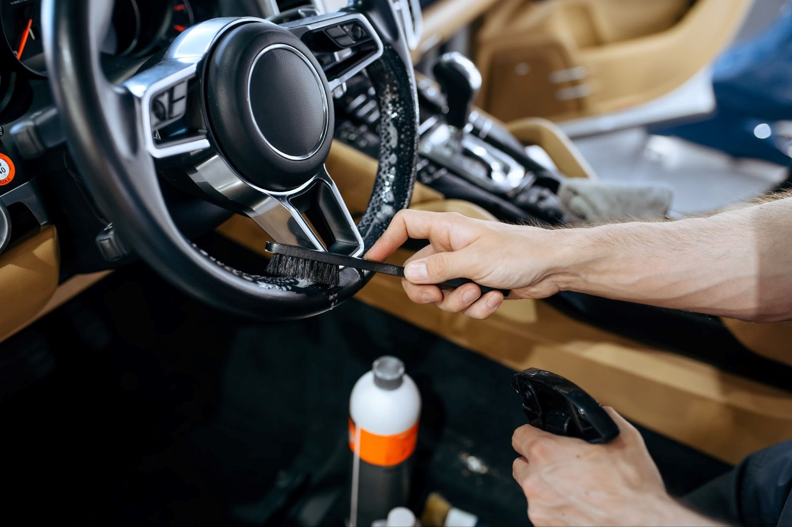 Worker-wiping-a-car-steering-wheel-detailing