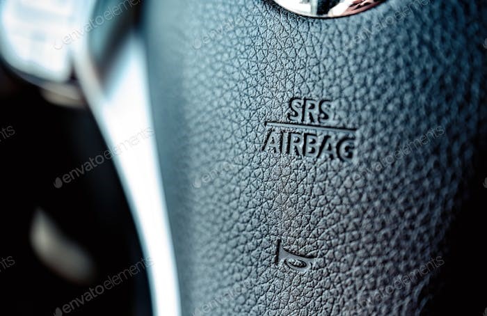 air bag sign on a-steer wheel in the car