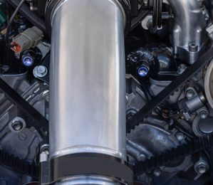 Close-up of a cambelt system inside a car engine, showcasing high-performance mechanical components serviced at Acton Service Centre.
