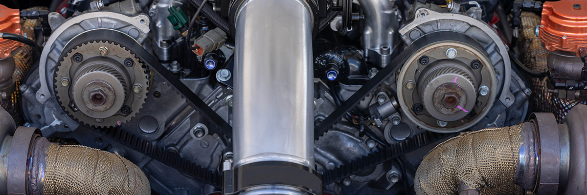 Close-up of a cambelt system inside a car engine, showcasing high-performance mechanical components serviced at Acton Service Centre.