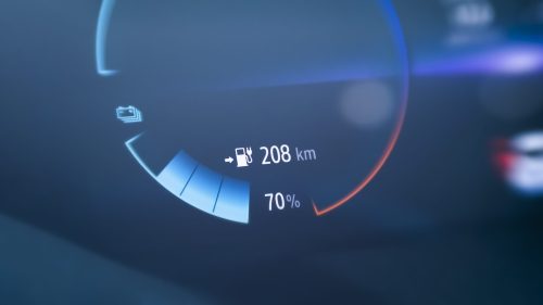 An electric car dashboard showing battery level and driving range for monitoring EV performance.